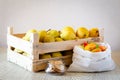 Fresh yellow pears in a wooden crate, pepper in a cloth bag and apple chips. Plastic free storage concept. Royalty Free Stock Photo
