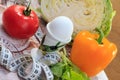 Pepper, egg, cabbage, tomato, salad and ruler on napkin Royalty Free Stock Photo