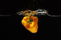 Fresh yellow pepper falling into water Royalty Free Stock Photo