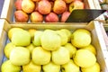 Fresh yellow and red apples with stickers in wood boxes for sale Royalty Free Stock Photo