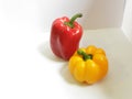 Fresh yellow and red bell peppers on a white background. Beautiful and shiny bell peppers Royalty Free Stock Photo