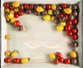 Fresh yellow, red and brown tomatoes from the market in a vintage tray Royalty Free Stock Photo