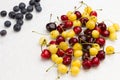 Fresh yellow and red cherry, Blueberry on white background Royalty Free Stock Photo