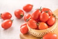 Fresh yellow and red cherry tomatoes in a basket on a cement board, close up, copy space, top view Royalty Free Stock Photo