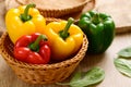 Fresh yellow, red and green bell peppers in a bamboo basket Royalty Free Stock Photo