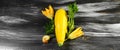 Fresh yellow zucchini and zucchini flowers on a black wooden table. Top view. Copy space Royalty Free Stock Photo