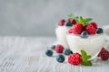 Fresh Yogurt with Mixed Berries and Mint on Rustic Table