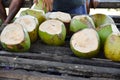 Fresh young coconuts are prepared for tourists