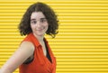 Fresh young girl brunette wearing orange on yellow stripe background Royalty Free Stock Photo