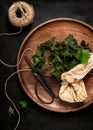 Fresh young stinging nettle leaves on a wooden pate.