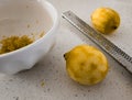 Fresh zested lemons with micro plane and bowl of zest Royalty Free Stock Photo