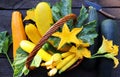 Fresh zucchini in a basket. Zucchini with flowers on the old rustic wooden table Royalty Free Stock Photo