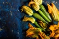 Fresh zucchini flowers and tropea onions over blue back Royalty Free Stock Photo