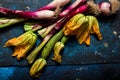 Fresh zucchini flowers and tropea onions over blue back Royalty Free Stock Photo