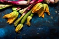 Fresh zucchini flowers and tropea onions over blue back Royalty Free Stock Photo