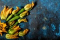 Fresh zucchini flowers and tropea onions over blue back Royalty Free Stock Photo