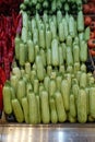 fresh zucchini in the greengrocer aisle, zucchini lined up for sale in large quantities