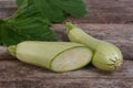 Fresh zucchini sliced with leaves on a old wooden Royalty Free Stock Photo