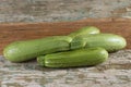 Fresh zucchinis on rustic wooden background