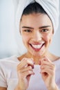 Freshening up to start a beautiful day. Portrait of a beautiful young woman flossing her teeth in the bathroom at home. Royalty Free Stock Photo