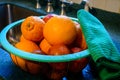 Freshley washed citrus fruit rests in a basket on the kitchen counter 1