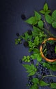 Freshly assorted berries in wooden bowl. Juicy and fresh blueberries6 blackberries and raspberries with green leaves on rustic Royalty Free Stock Photo