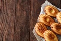 Freshly baked almond cookies piled on ceramic plate over rustic background, top view, close-up, selective focus Royalty Free Stock Photo