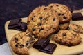 Freshly baked American chocolate chip cookies on rustic brown wooden table background. Royalty Free Stock Photo