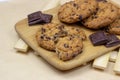 Freshly baked American chocolate chip cookies on rustic brown wooden table background. Royalty Free Stock Photo