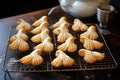 freshly baked angel-shaped cookies on cooling rack