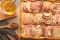 Freshly baked apple pie with nuts and ingredients on wooden table, flat lay