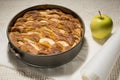 Freshly baked apple pie in round form, on the table, golden crust Royalty Free Stock Photo