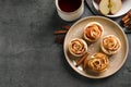 Freshly baked apple roses on grey table, flat lay. Space for text Royalty Free Stock Photo