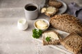 Freshly baked artisan multigrain bread with butter and pate. Breakfast with coffee, sliced bread, butter and liver pate