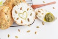 Freshly baked bagel with Philadelphia cheese, sunflower seeds and a painted heart with pesto sauce. Delicious and healthy Royalty Free Stock Photo