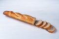 freshly baked baguette and slices on white background, top view Royalty Free Stock Photo