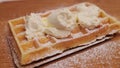 Freshly baked Belgian Waffel with sugar and whipped cream
