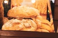 Freshly baked big crusty round bread loafs with flour stacked on top of each other in a bakery / market stall shop surroundings Royalty Free Stock Photo