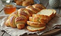 Freshly baked braided bread with sliced loaf and honey on rustic table setting Royalty Free Stock Photo