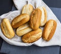 Freshly baked bread buns on a linen towel, whole bread buns heap