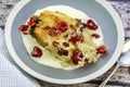 Freshly baked bread and butter pudding served on a plate with cream. Royalty Free Stock Photo