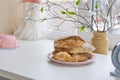 Freshly baked bread and croissants on plate near the window