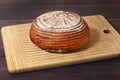 Freshly baked bread lie on a wooden board. Rye round bread. Selective focus