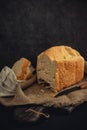 Freshly baked bread lies on a burlap and on a cutting board.