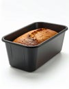 Freshly Baked Bread Loaf in Dark Pan on Clean White Background Royalty Free Stock Photo