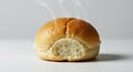 Freshly Baked Bread Roll with Steam and a Bite Taken Out Royalty Free Stock Photo
