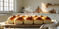Freshly Baked Bread Rolls on Wooden Cutting Board in Bright Kitchen with Natural Light Royalty Free Stock Photo
