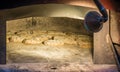 Freshly baked bread in rustic bakery with traditional old stone oven Royalty Free Stock Photo