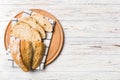 Freshly baked bread slices on cutting board against white wooden background. top view Sliced bread Royalty Free Stock Photo