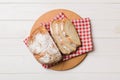 Freshly baked bread slices on cutting board against white wooden background. top view Sliced bread Royalty Free Stock Photo